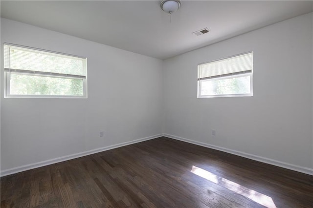 empty room with dark hardwood / wood-style floors