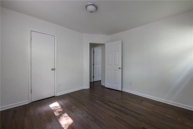 unfurnished bedroom featuring dark wood-type flooring