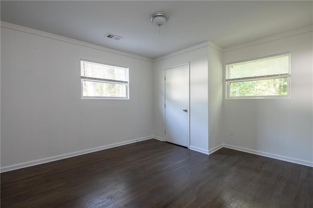 unfurnished bedroom featuring dark wood-type flooring and multiple windows