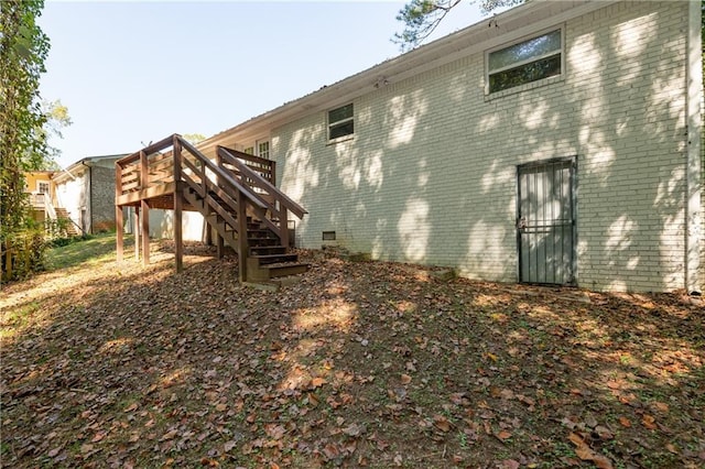 view of property exterior with a wooden deck