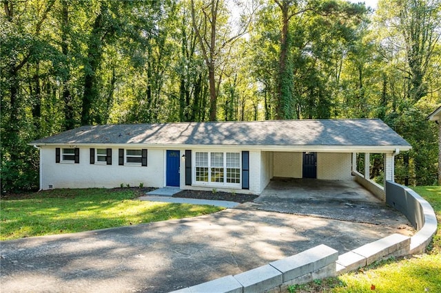 ranch-style house featuring a carport and a front lawn