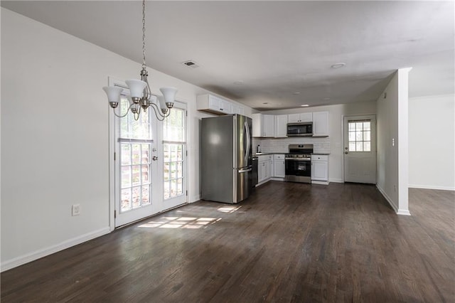 kitchen featuring decorative light fixtures, tasteful backsplash, white cabinets, stainless steel appliances, and dark wood-type flooring