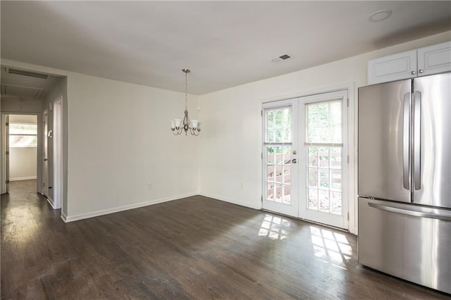 unfurnished dining area featuring french doors and dark hardwood / wood-style flooring