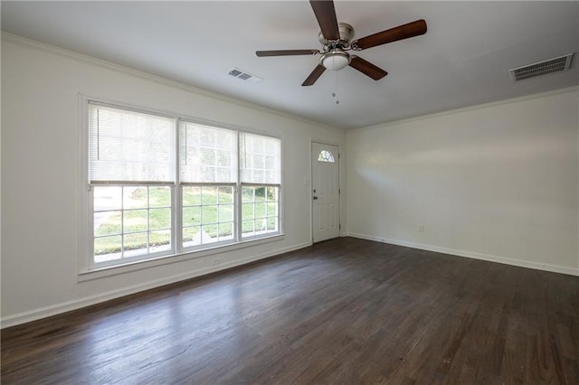 spare room with crown molding, dark hardwood / wood-style floors, and ceiling fan