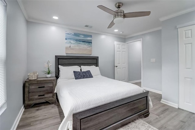 bedroom with crown molding, light hardwood / wood-style flooring, and ceiling fan