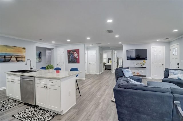 interior space with crown molding, sink, and light hardwood / wood-style floors