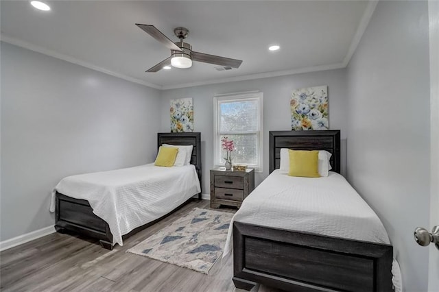 bedroom featuring crown molding, ceiling fan, and wood-type flooring