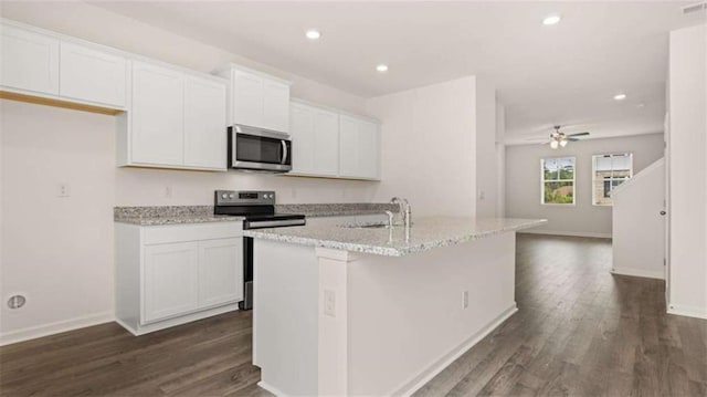 kitchen with white cabinets, appliances with stainless steel finishes, dark hardwood / wood-style flooring, and an island with sink