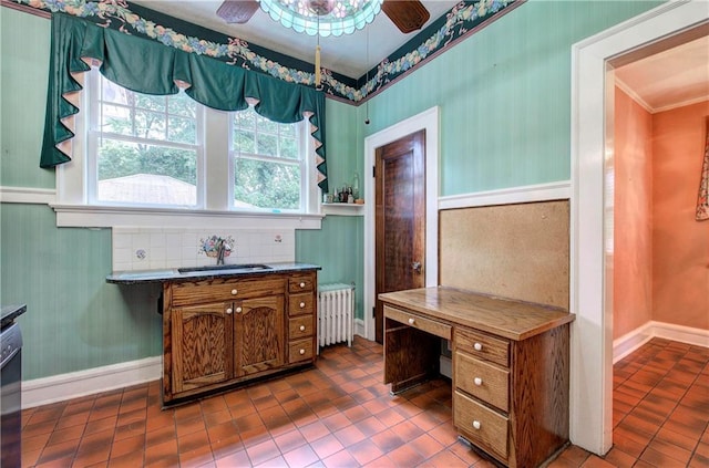 home office featuring sink, crown molding, radiator, dark tile patterned floors, and ceiling fan