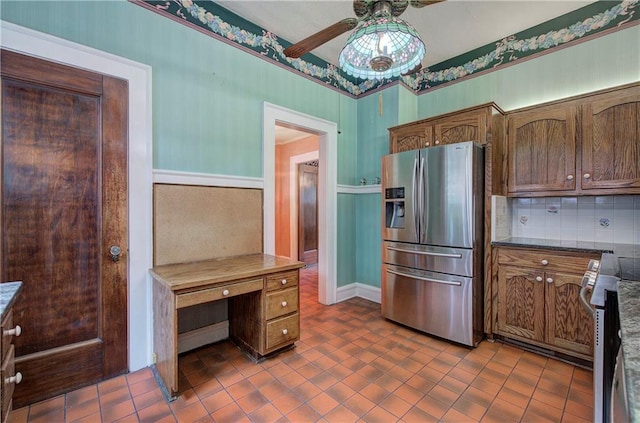 kitchen with tasteful backsplash, dark tile patterned floors, ceiling fan, and appliances with stainless steel finishes