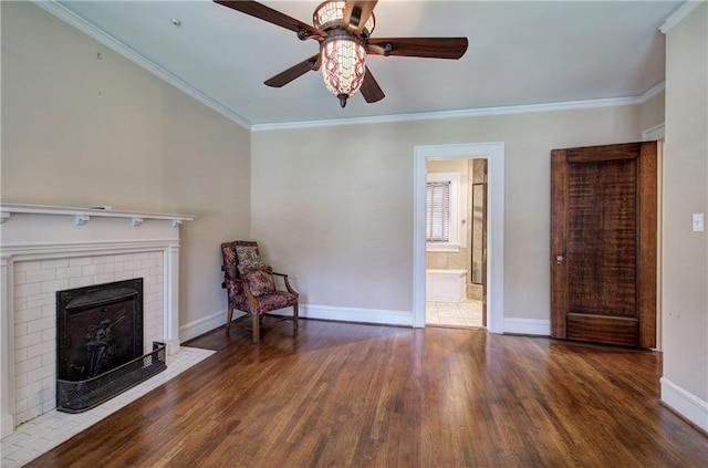 unfurnished living room with ornamental molding, dark hardwood / wood-style floors, ceiling fan, and a fireplace