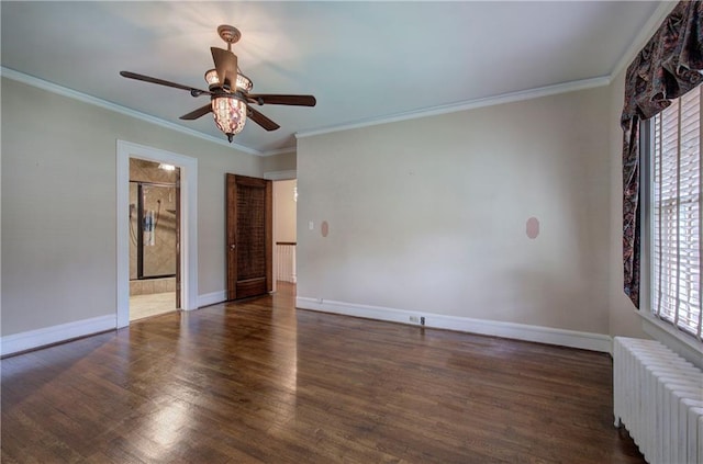 empty room featuring ornamental molding, radiator, ceiling fan, and dark hardwood / wood-style floors