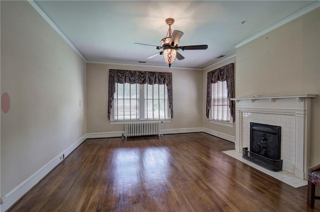 unfurnished living room with crown molding, radiator heating unit, dark hardwood / wood-style flooring, and a brick fireplace