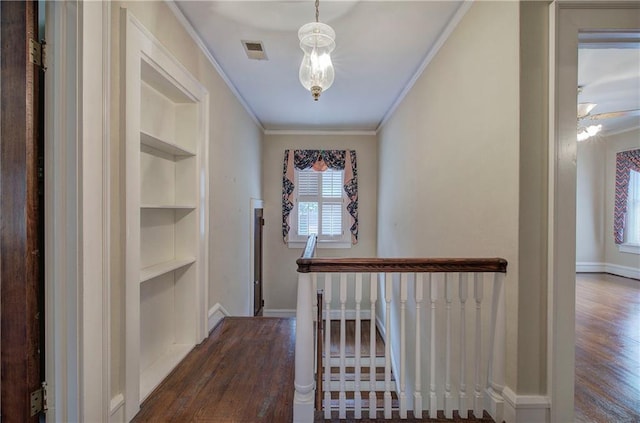 corridor featuring crown molding, dark hardwood / wood-style floors, and built in shelves