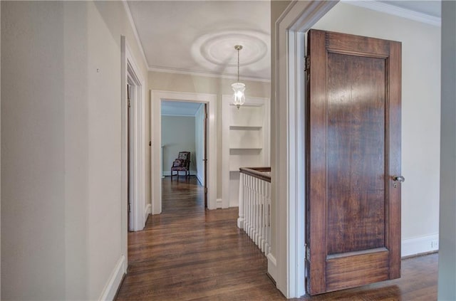 hallway with crown molding, dark hardwood / wood-style floors, and built in shelves