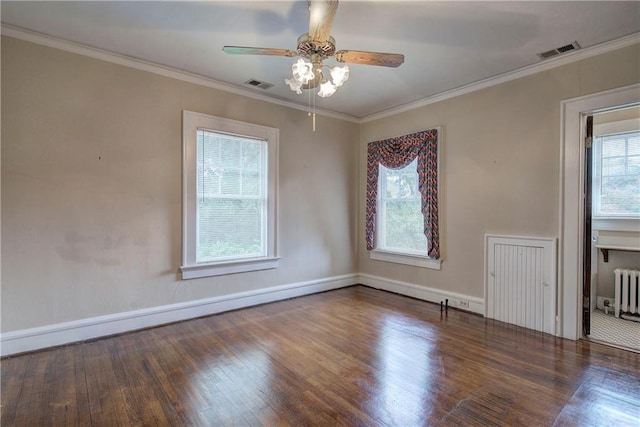 empty room with crown molding, ceiling fan, radiator heating unit, and dark hardwood / wood-style floors