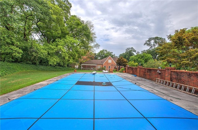 view of swimming pool with a patio area and a lawn