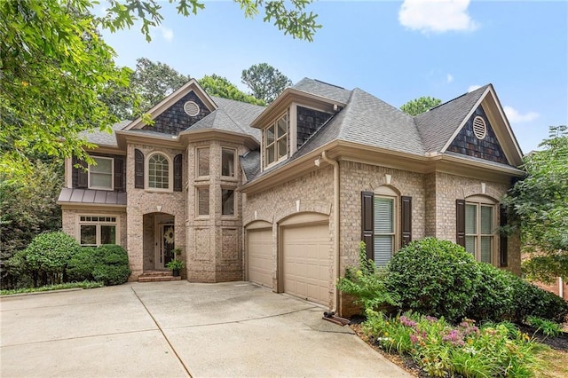 5355 Highland Pine Ln, Mableton, GA 30126 - french country style house with concrete driveway, brick siding, and roof with shingles