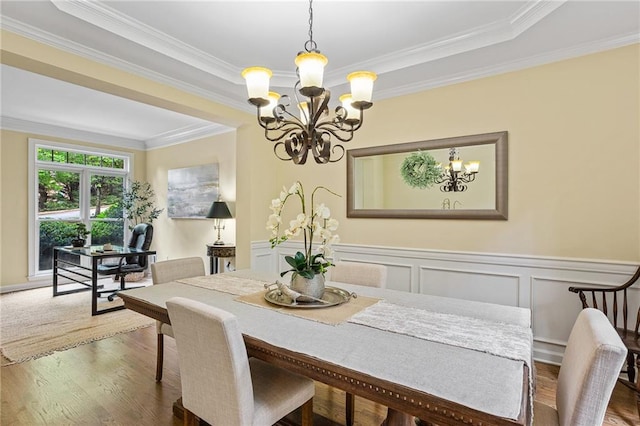 5355 Highland Pine Ln, Mableton, GA 30126 - dining area featuring a chandelier, crown molding, wood finished floors, and a wainscoted wall