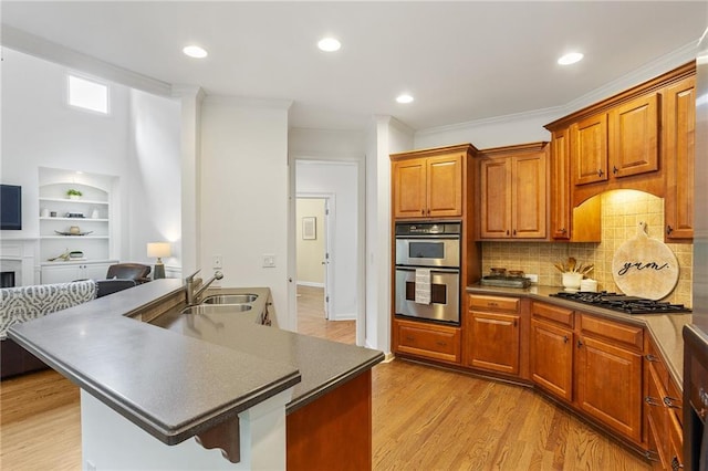 5355 Highland Pine Ln, Mableton, GA 30126 - kitchen with stainless steel double oven, gas cooktop, open floor plan, dark countertops, and ornamental molding