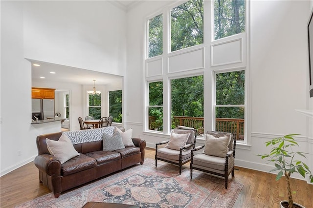 5355 Highland Pine Ln, Mableton, GA 30126 - living area with wood finished floors, a towering ceiling, and a chandelier