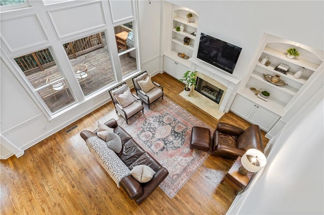 5355 Highland Pine Ln, Mableton, GA 30126 - living area with wood finished floors, a fireplace, and built in shelves