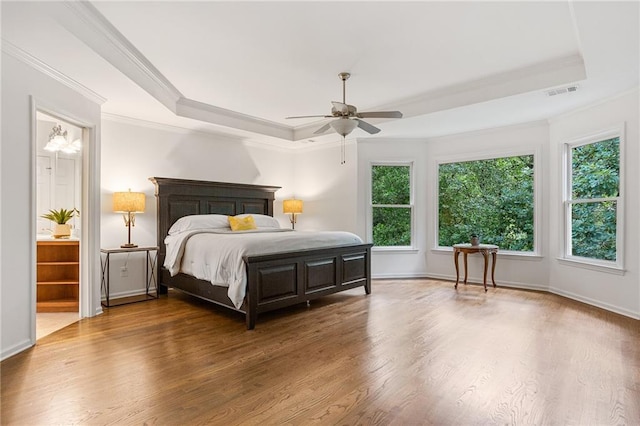 5355 Highland Pine Ln, Mableton, GA 30126 - bedroom featuring a tray ceiling, multiple windows, wood finished floors, and ornamental molding