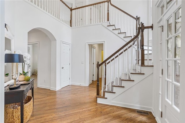 5355 Highland Pine Ln, Mableton, GA 30126 - entrance foyer with a high ceiling, wood finished floors, stairs, and arched walkways