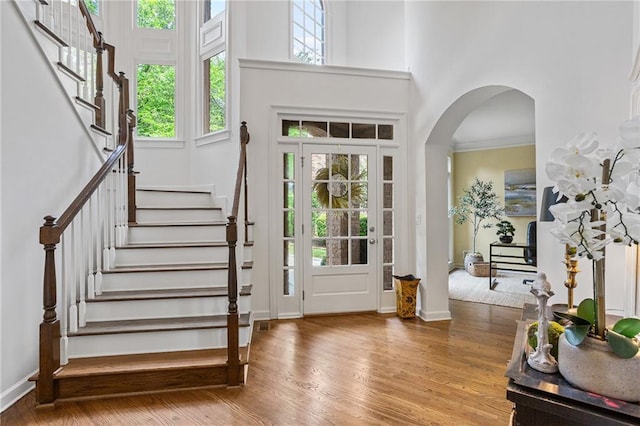 5355 Highland Pine Ln, Mableton, GA 30126 - foyer featuring stairs, wood finished floors, a high ceiling, and arched walkways