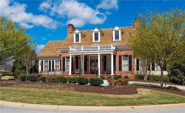 5355 Highland Pine Ln, Mableton, GA 30126 - georgian-style home featuring a porch, brick siding, a balcony, and a front lawn