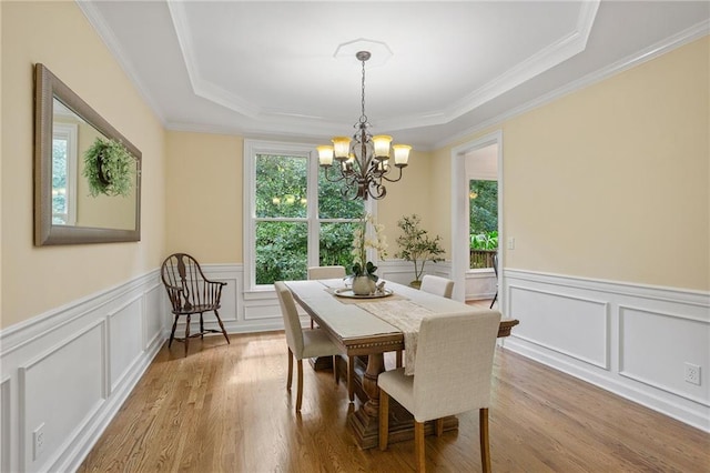 5355 Highland Pine Ln, Mableton, GA 30126 - dining room with a tray ceiling, a chandelier, wood finished floors, ornamental molding, and wainscoting