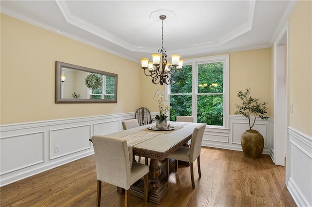 5355 Highland Pine Ln, Mableton, GA 30126 - dining room featuring healthy amount of natural light, a chandelier, a raised ceiling, wood finished floors, and ornamental molding