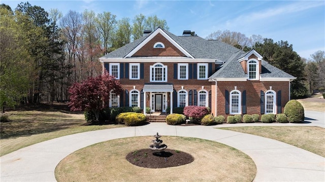 3230 Munsey Ct, Cumming, GA 30041 - colonial home with brick siding, a front lawn, and curved driveway