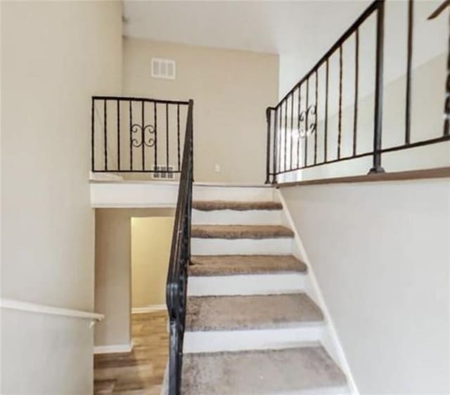 stairs with hardwood / wood-style flooring