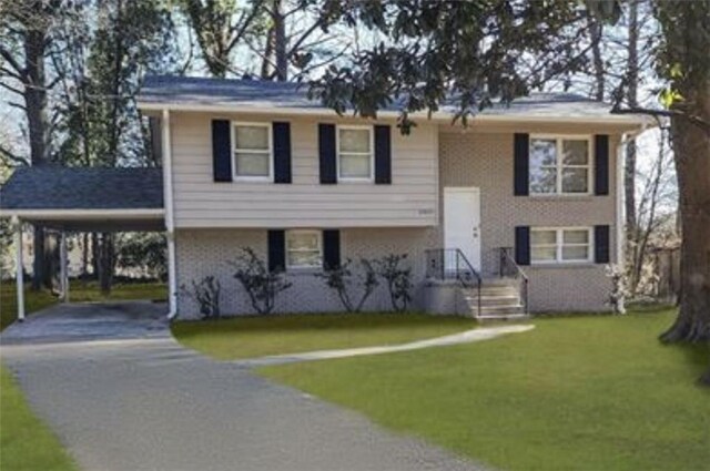 bi-level home featuring a carport and a front lawn