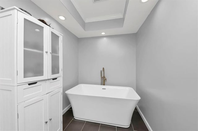 bathroom with tile patterned floors and a tub