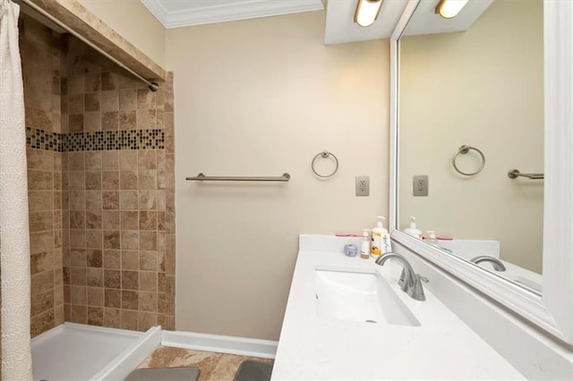 bathroom featuring a tile shower, vanity, and ornamental molding