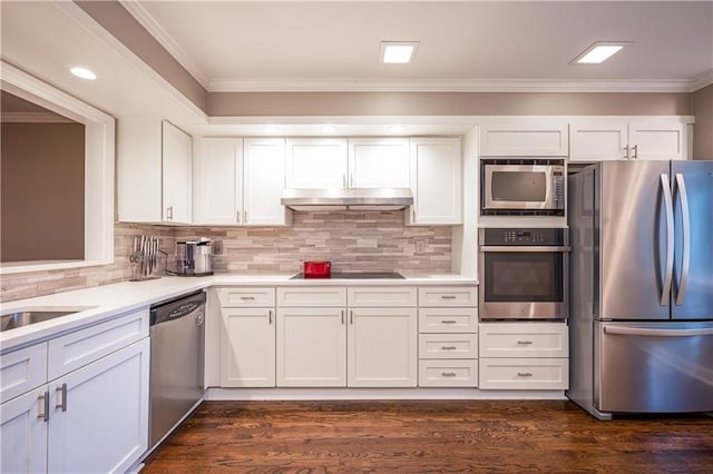 kitchen with appliances with stainless steel finishes, white cabinetry, dark wood-type flooring, and crown molding