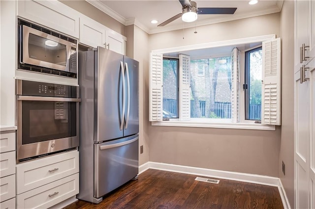 kitchen featuring white cabinets, dark hardwood / wood-style floors, ornamental molding, and appliances with stainless steel finishes