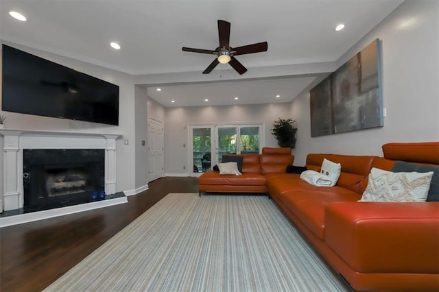 living room featuring hardwood / wood-style floors and ceiling fan