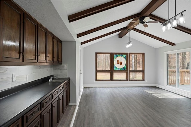 bar with baseboards, decorative backsplash, decorative light fixtures, vaulted ceiling with beams, and light wood-style floors