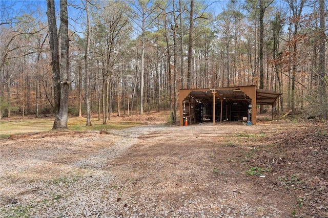 exterior space featuring a view of trees and an outbuilding