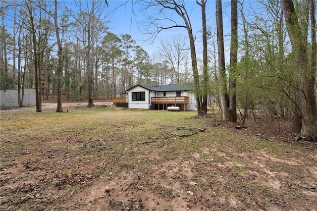 view of yard with a deck and fence