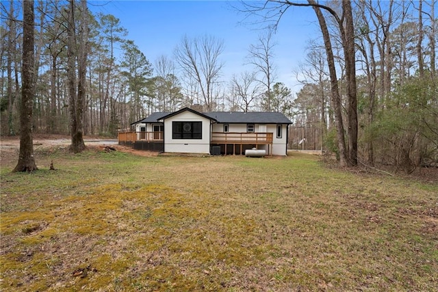 back of house with crawl space, a yard, and a wooden deck