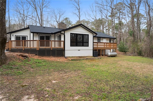 rear view of house featuring a yard, crawl space, roof with shingles, a wooden deck, and a chimney