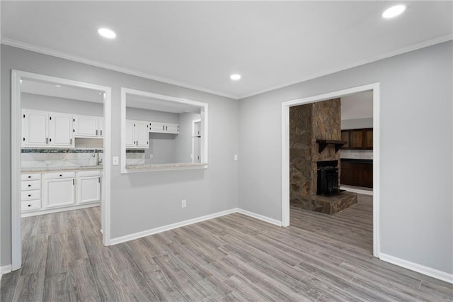 unfurnished room with baseboards, ornamental molding, recessed lighting, and light wood-style floors