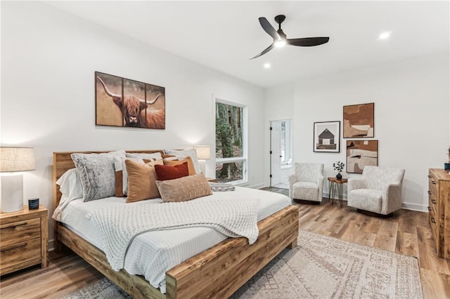 bedroom with a ceiling fan, recessed lighting, baseboards, and wood finished floors