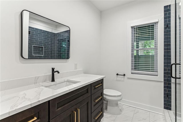 bathroom with baseboards, toilet, marble finish floor, vanity, and a shower stall