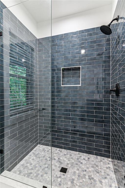 bathroom with tiled shower