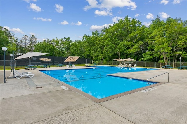 pool with fence and a patio